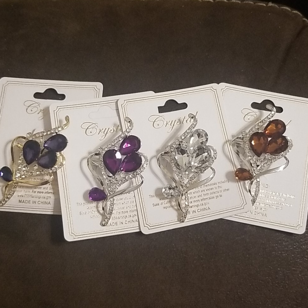 Four different floral bouquet brooches/pins
